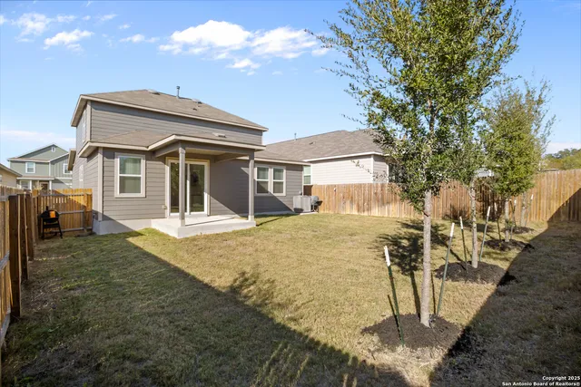 a view of a house with a yard and garage