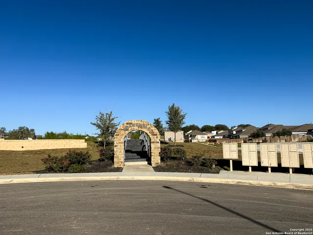 a front view of a house with a yard and lake view