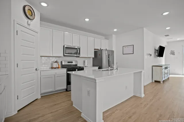 a kitchen with cabinets a sink and a stove top oven