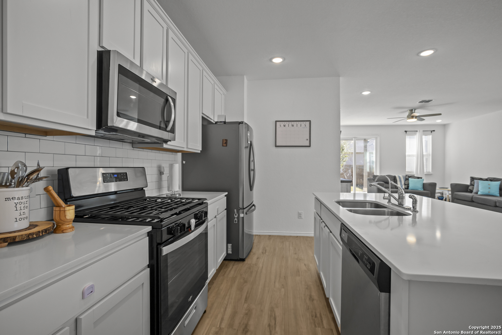 13222 Hagerd Loop St. Hedwig, TX 78152 - Photo 8 of 37 a kitchen with stainless steel appliances granite countertop a sink stove and refrigerator