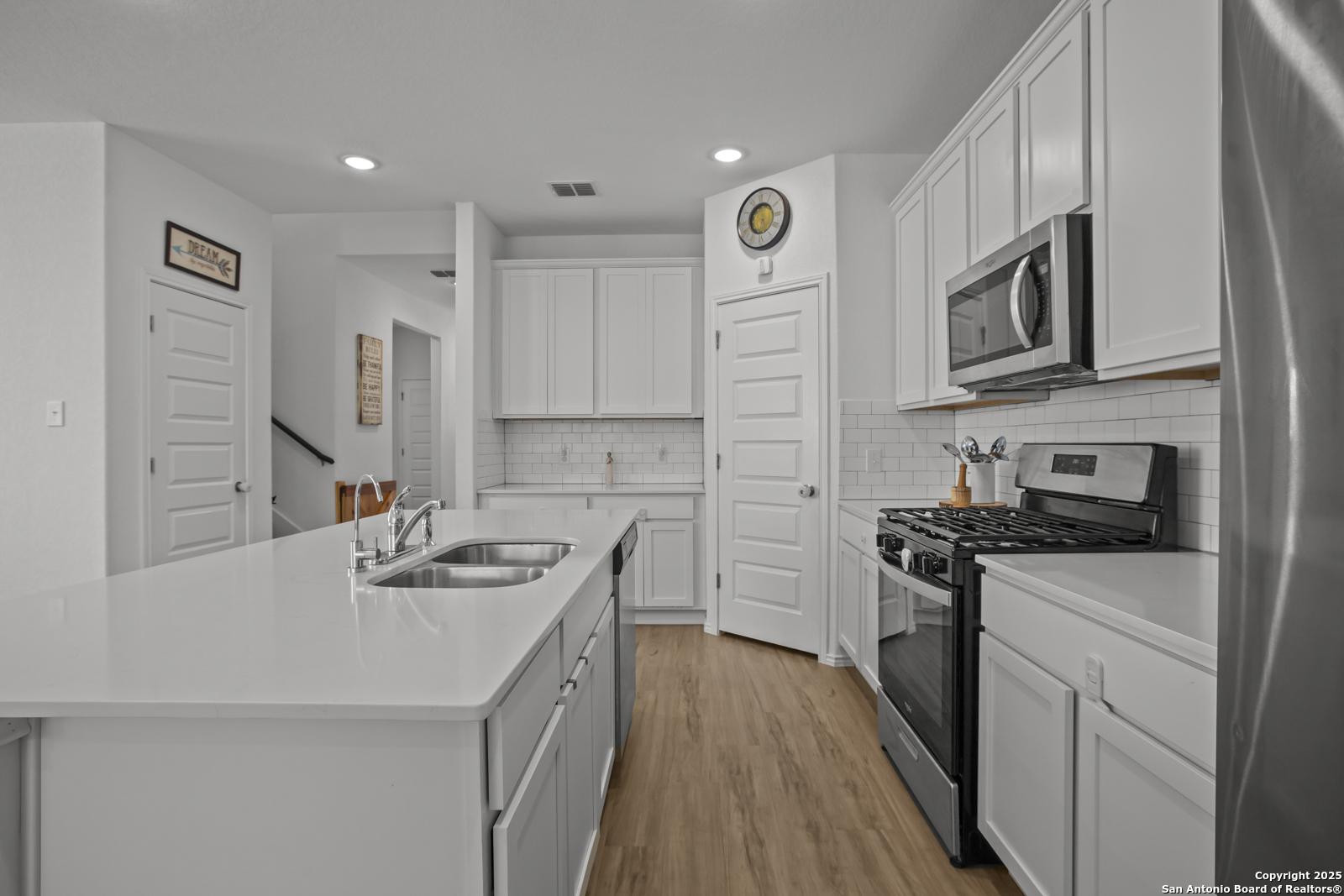13222 Hagerd Loop St. Hedwig, TX 78152 - Photo 9 of 37 a kitchen with stainless steel appliances granite countertop a sink stove microwave and refrigerator