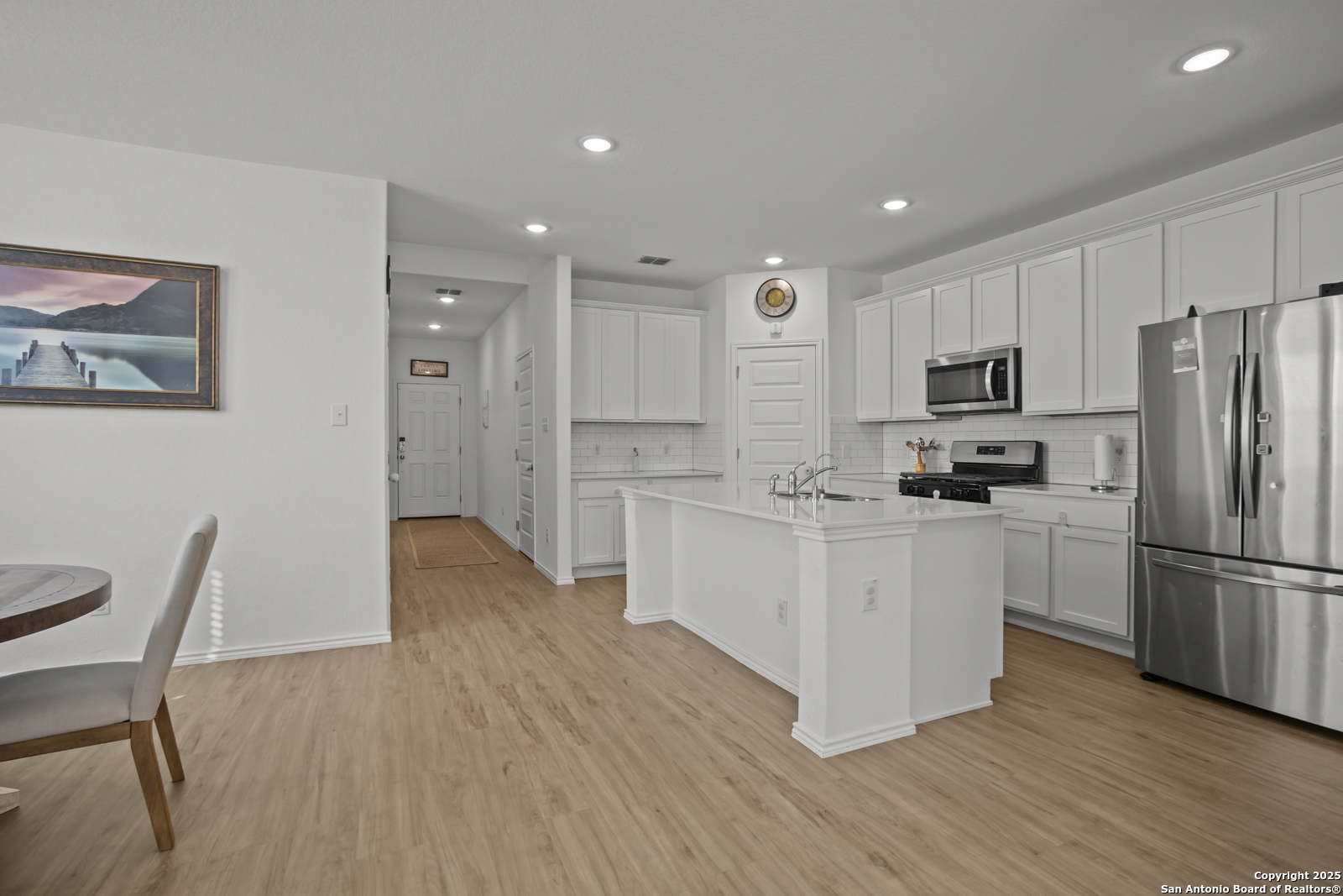 13222 Hagerd Loop St. Hedwig, TX 78152 - Photo 10 of 37 a kitchen with a refrigerator cabinets and wooden floor