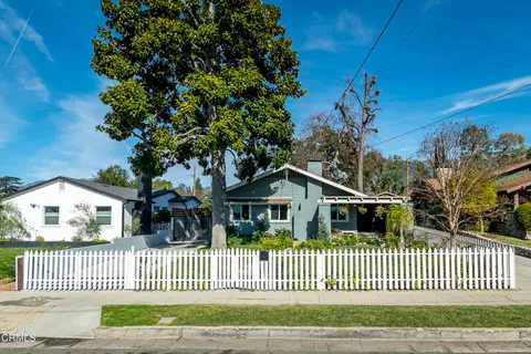 a view of a house with wooden fence