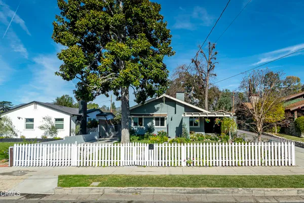 a view of a house with wooden fence
