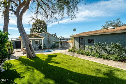 a view of a house with pool and sitting area