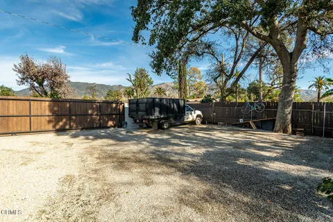 a view of a backyard with large trees