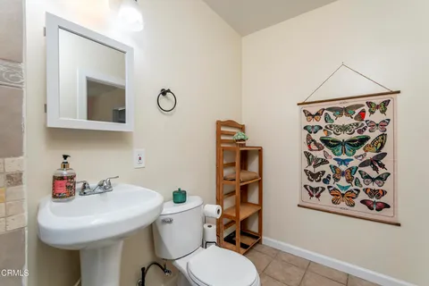 a bathroom with a toilet a sink and a mirror