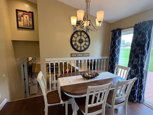 a view of a dining room with furniture wooden floor and chandelier