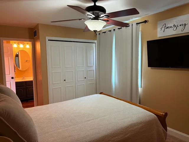 a bedroom with a bed and a chandelier