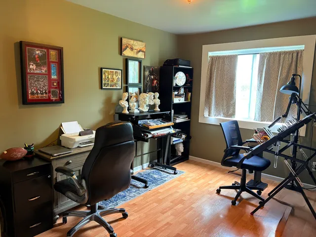 a view of a workspace with furniture and a window