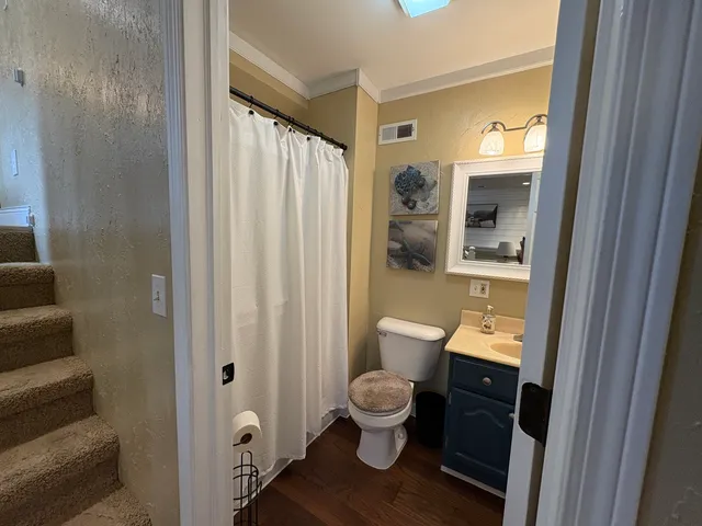 a bathroom with a toilet a sink and a mirror