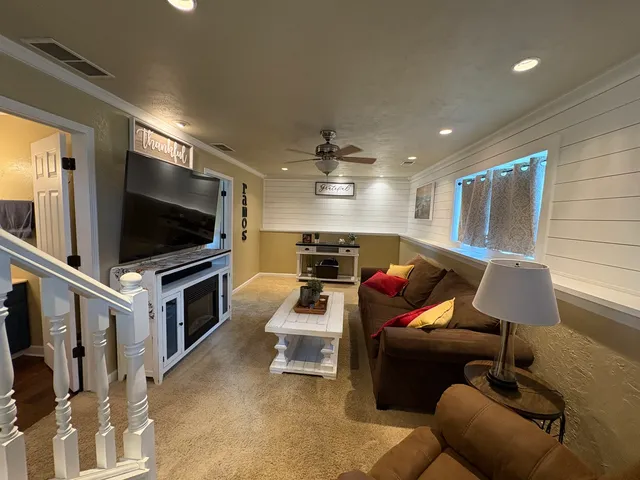 a living room with furniture and a flat screen tv