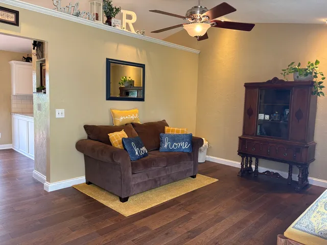 a living room with furniture and a wooden floor