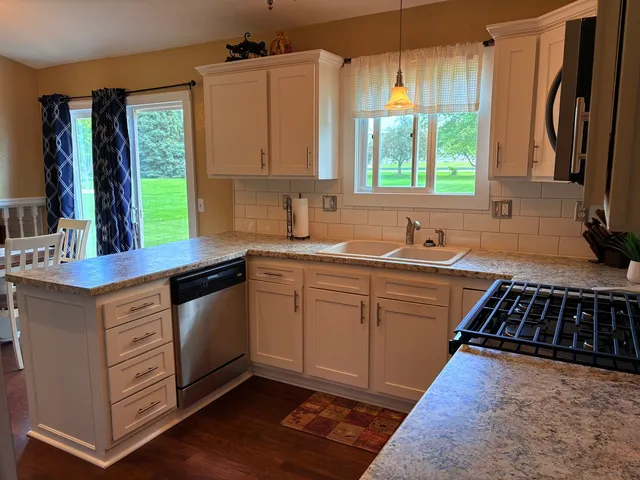 a kitchen with a sink stove and cabinets