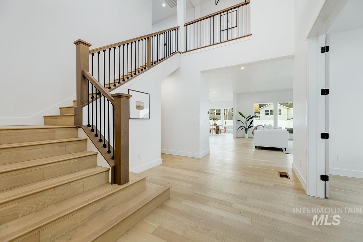 13624 North Ruffed Grouse Way Boise, ID 83714 - Photo 20 of 41 Stairway with wood finished floors, recessed lighting, and a towering ceiling