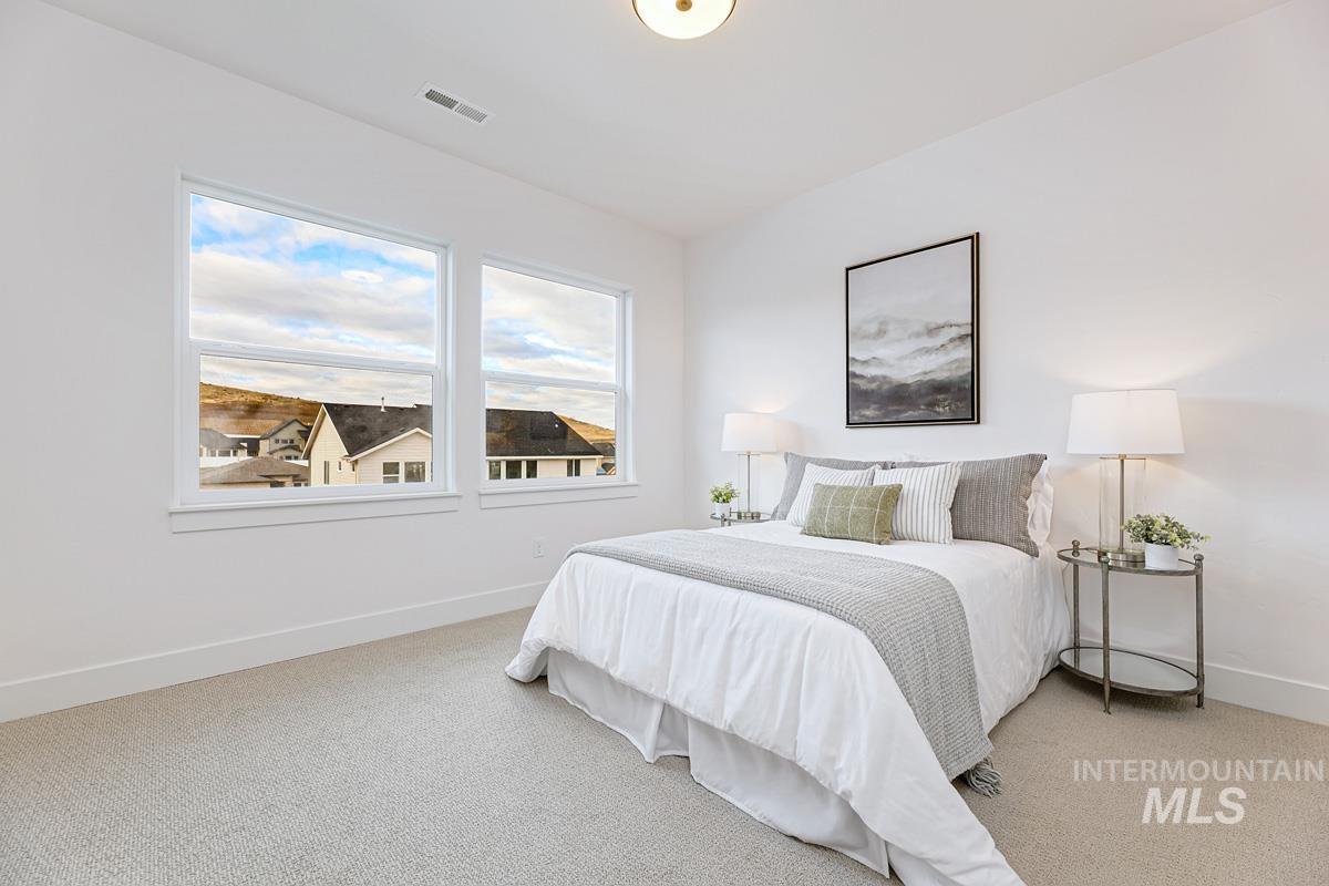 13624 North Ruffed Grouse Way Boise, ID 83714 - Photo 27 of 41 Carpeted bedroom featuring baseboards
