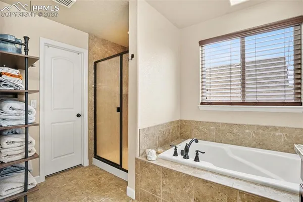 a bathroom with a bathtub and a shower
