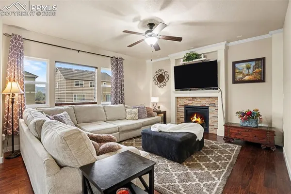 a living room with furniture a flat screen tv and a fireplace