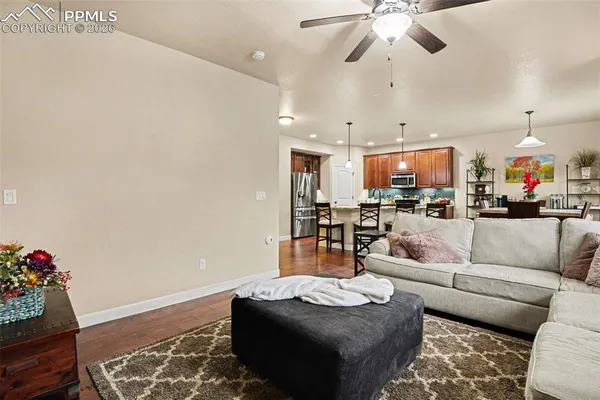 a living room with furniture and a chandelier