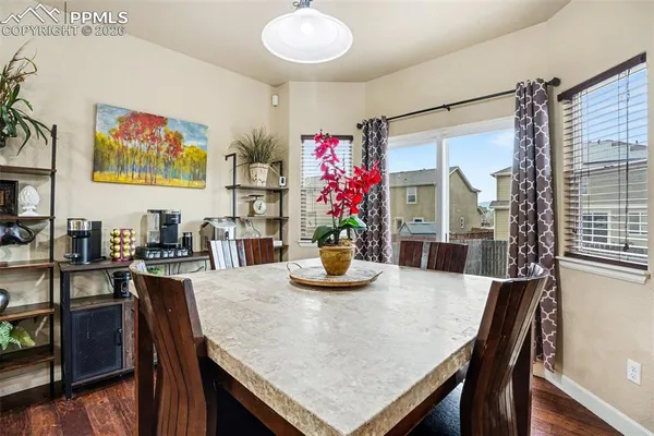 a view of a dining room with furniture and wooden floor