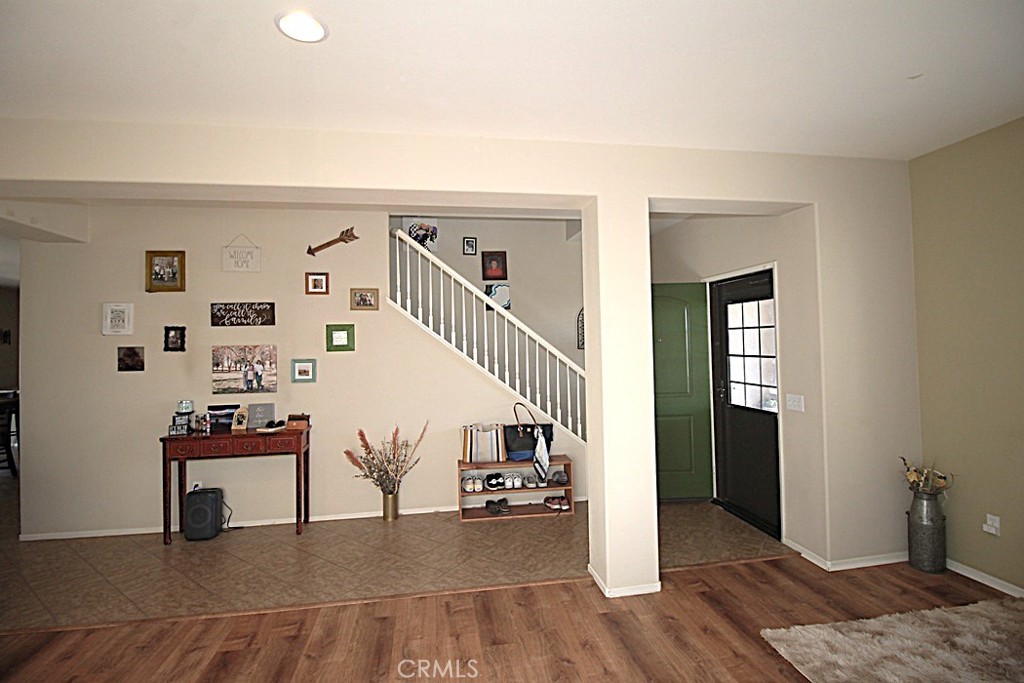 924 Condor Street Barstow, CA 92311 - Photo 8 of 52 a view of a livingroom with wooden floor and stairs