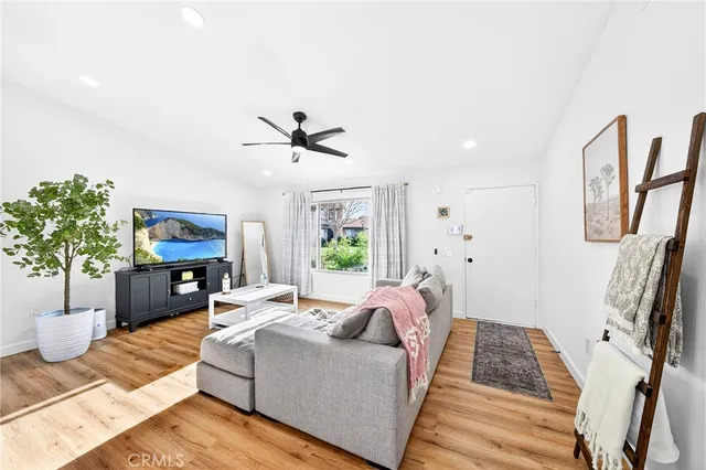 a living room with furniture fireplace and a potted plant