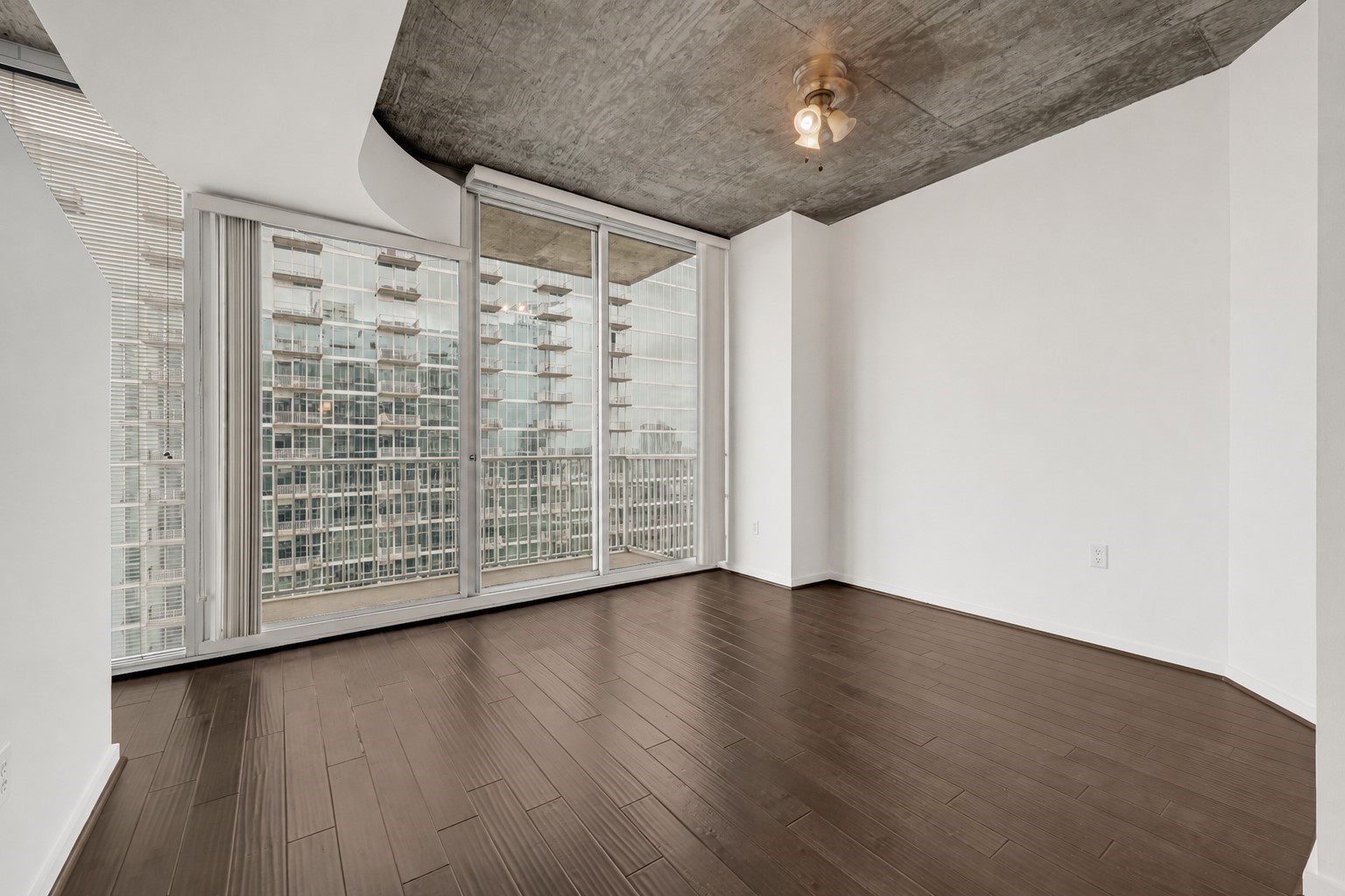 5925 Almeda Road, Unit 12308 Houston, TX 77004 - Photo 6 of 48 a view of an empty room with wooden floor and a window