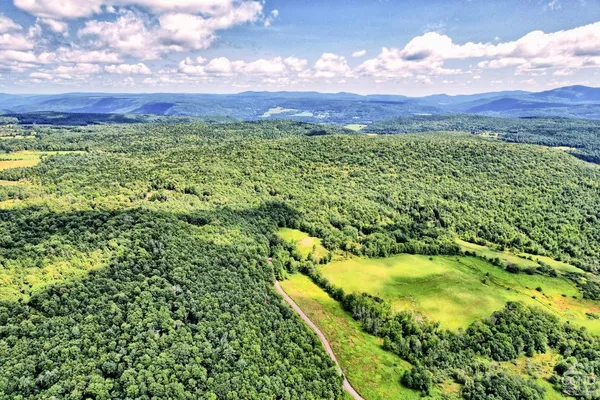 a dining hall with lots of tables a large window and chairs