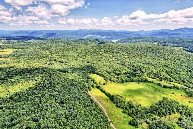 a dining hall with lots of tables a large window and chairs