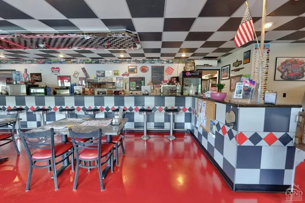 a kitchen with a stove and a chandelier