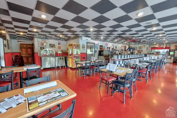 a view of a kitchen with fridge and a sink