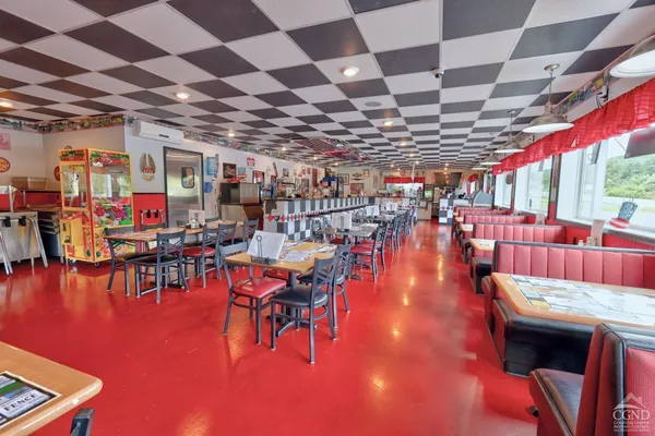 a room with stainless steel appliances and furniture