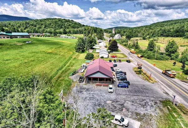 a aerial view of a house with garden space pool outdoor seating and yard