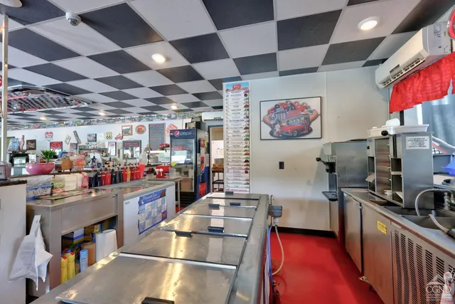 a view of a house with table and chairs under an umbrella
