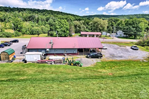 a view of a swimming pool with lawn chairs and a yard