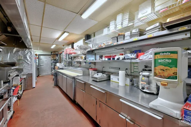 a view of a house with a deck and a yard