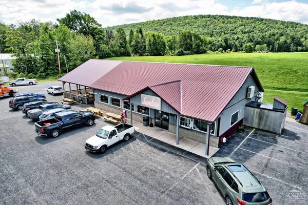 a aerial view of a house with table and chairs