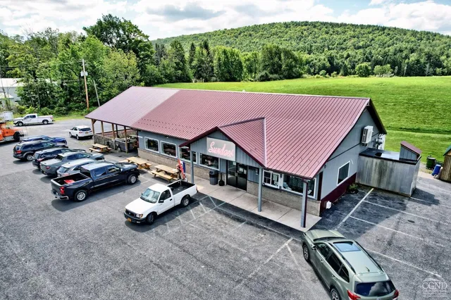 a aerial view of a house with table and chairs