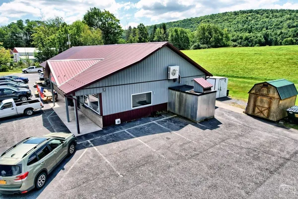 an aerial view of a house with a ocean view