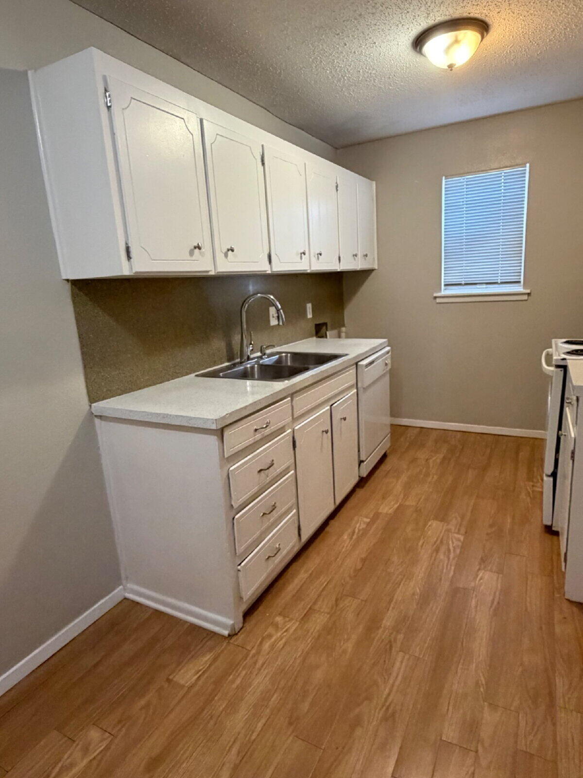 3211 35th Street, Unit E Lubbock, TX 79413 - Photo 6 of 13 a kitchen with a sink and cabinets