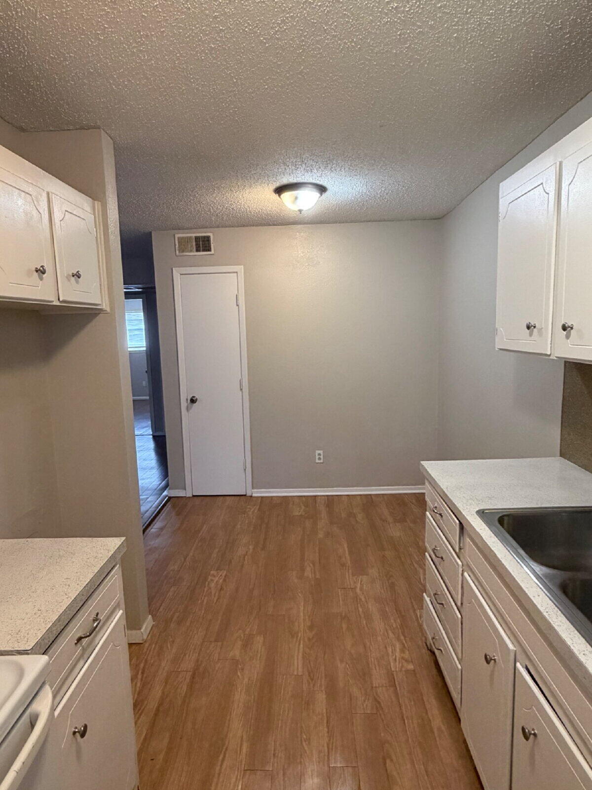 3211 35th Street, Unit E Lubbock, TX 79413 - Photo 8 of 13 a kitchen with a sink and cabinets