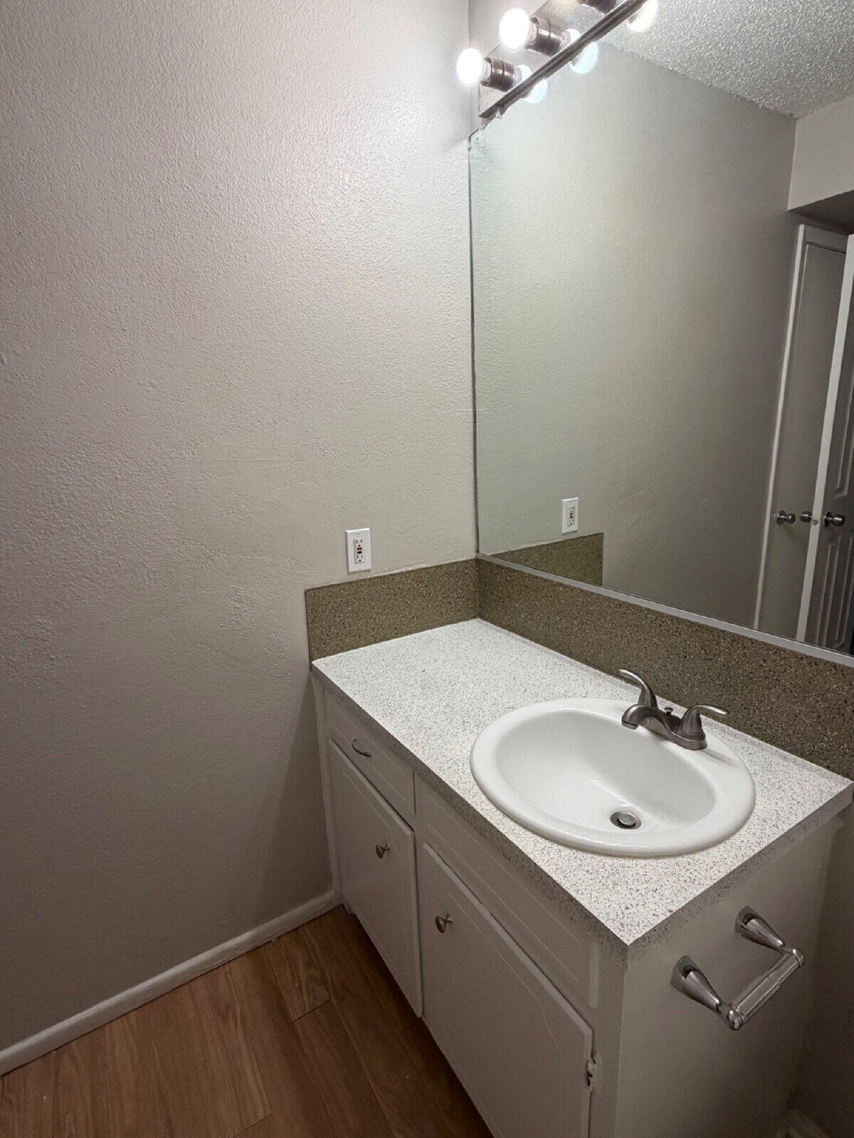 3211 35th Street, Unit E Lubbock, TX 79413 - Photo 9 of 13 a bathroom with a sink and a mirror