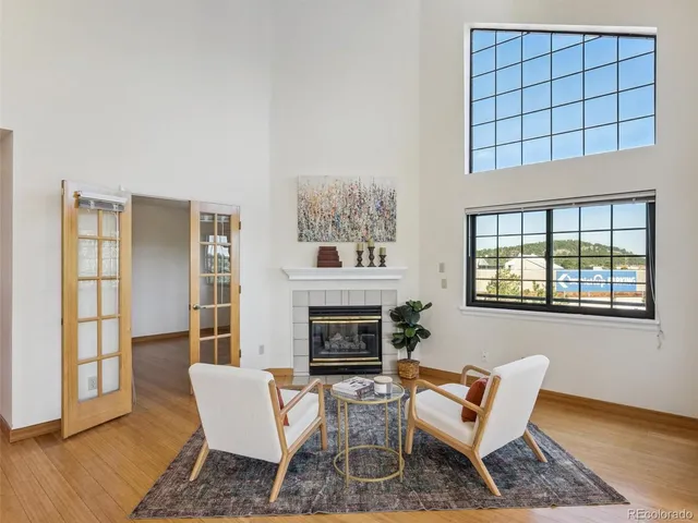 a living room with furniture a fireplace and wooden floor