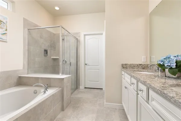 a bathroom with a granite countertop sink a toilet and shower