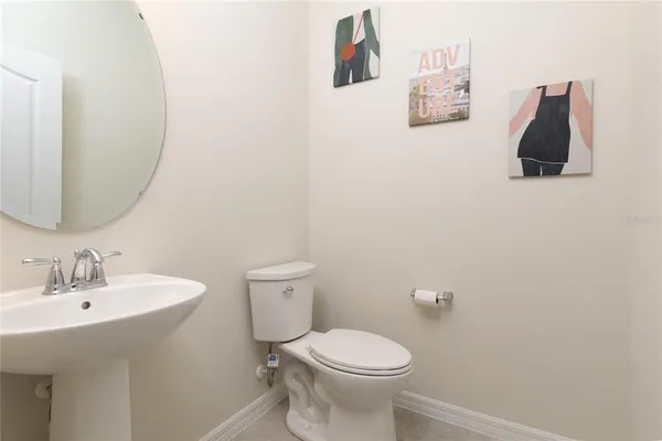 a white toilet sitting next to a bathroom sink