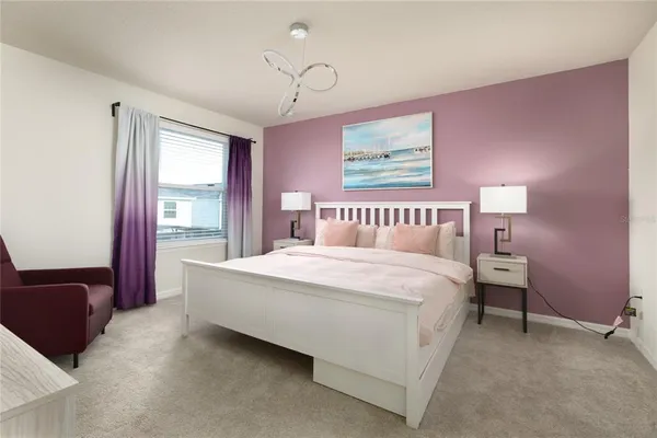 a spacious bedroom with a bed and window