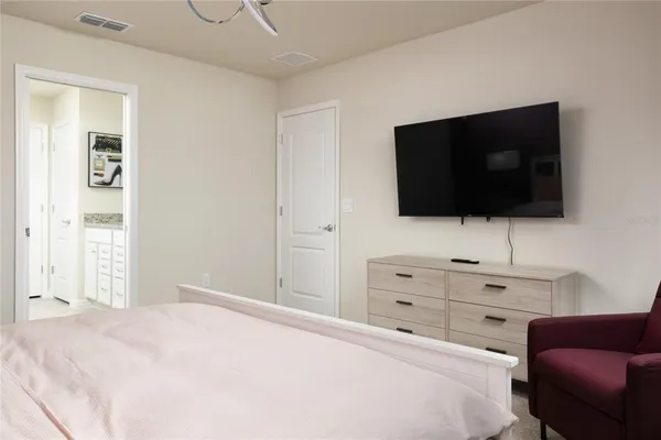 a bedroom with a bed and a flat screen tv