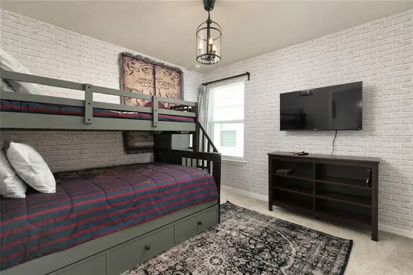 a bedroom with furniture and a flat screen tv