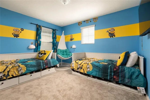 a bed sitting in a bedroom next to a window