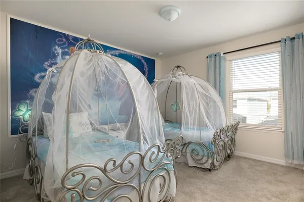 a living room with a flat screen tv and white walls